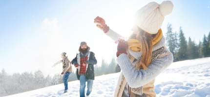 Junges Paar bei Schneeballschlacht.