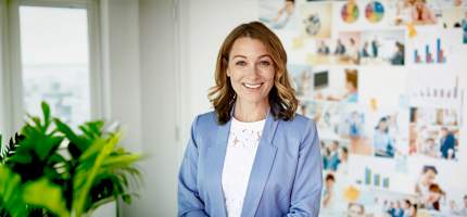 Eine Frau steht im Büro vor einer Pinnwand