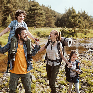 Familie mit zwei Kindern wandert in der Natur.